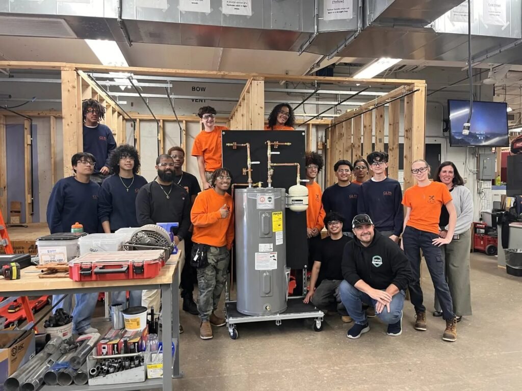 Plumbing students, instructors and partners with the training rig donated by RCF