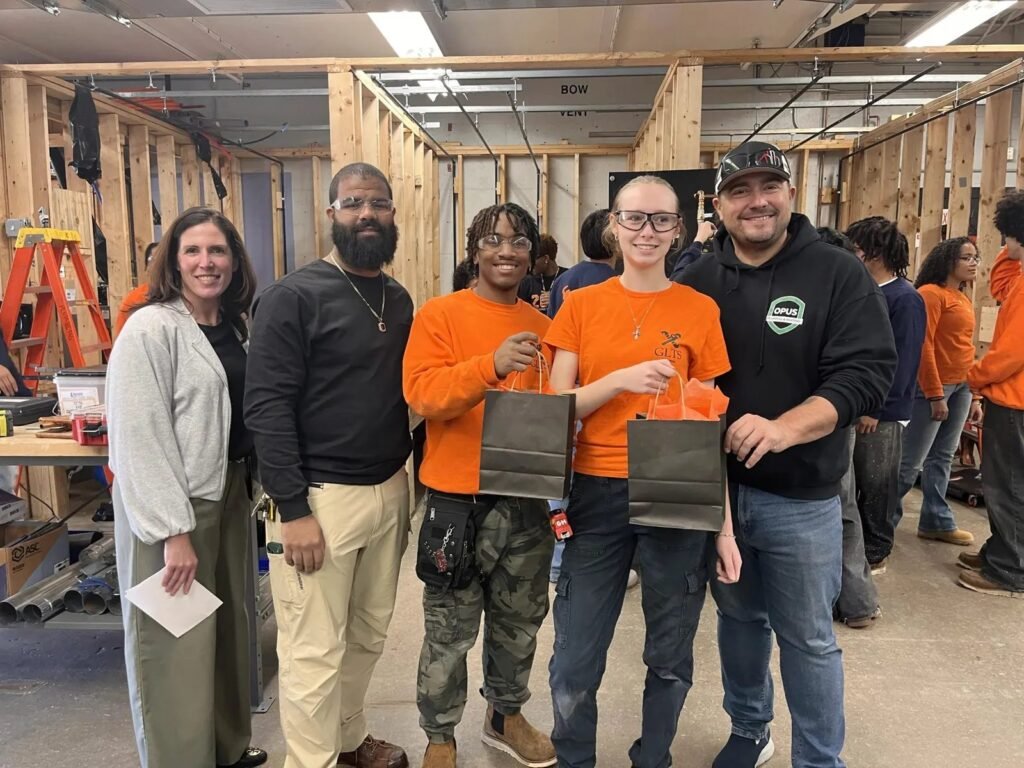 Students recognized by school staff and an Opus Plumbing & Heating representative